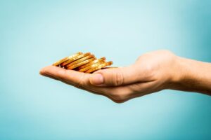 money being held in the palm of a hand