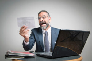 Shocked man holding a tax notice