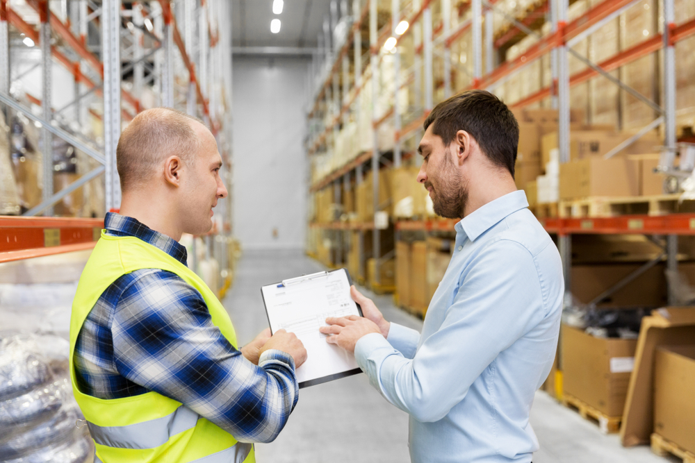Warehouse staff reviewing inventory documents as part of Asset Valuations in an insolvency process